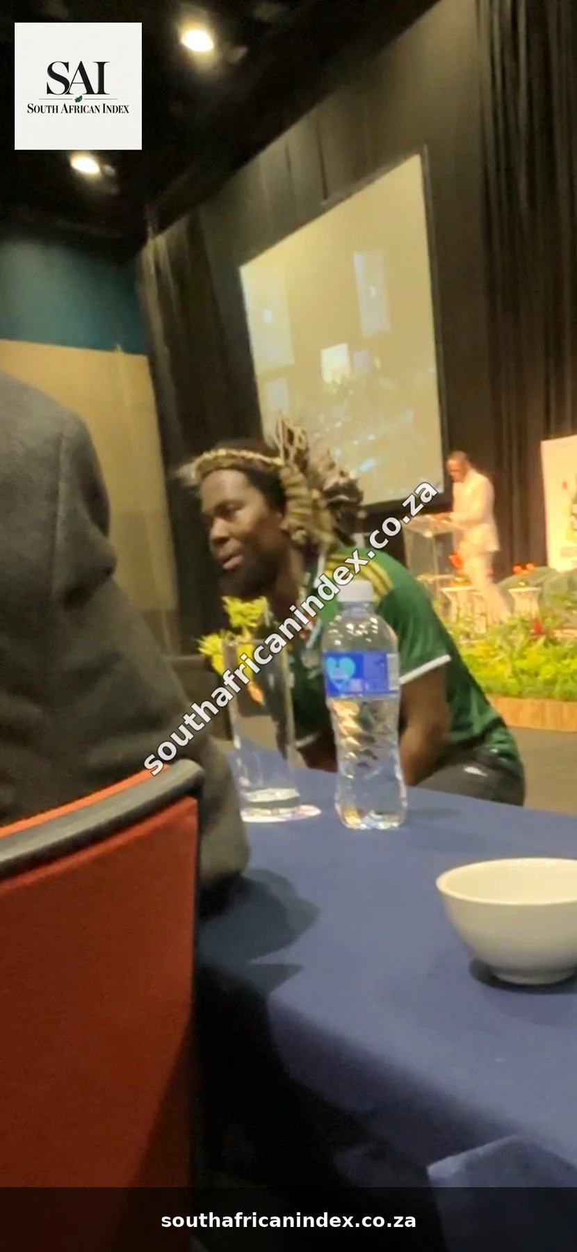 Phakelumthakathi kneeling beside a delegates’ table in front of the stage after his apology.